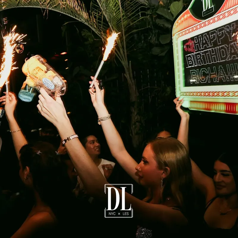 Birthday bottle service with sparklers and a light-up birthday sign