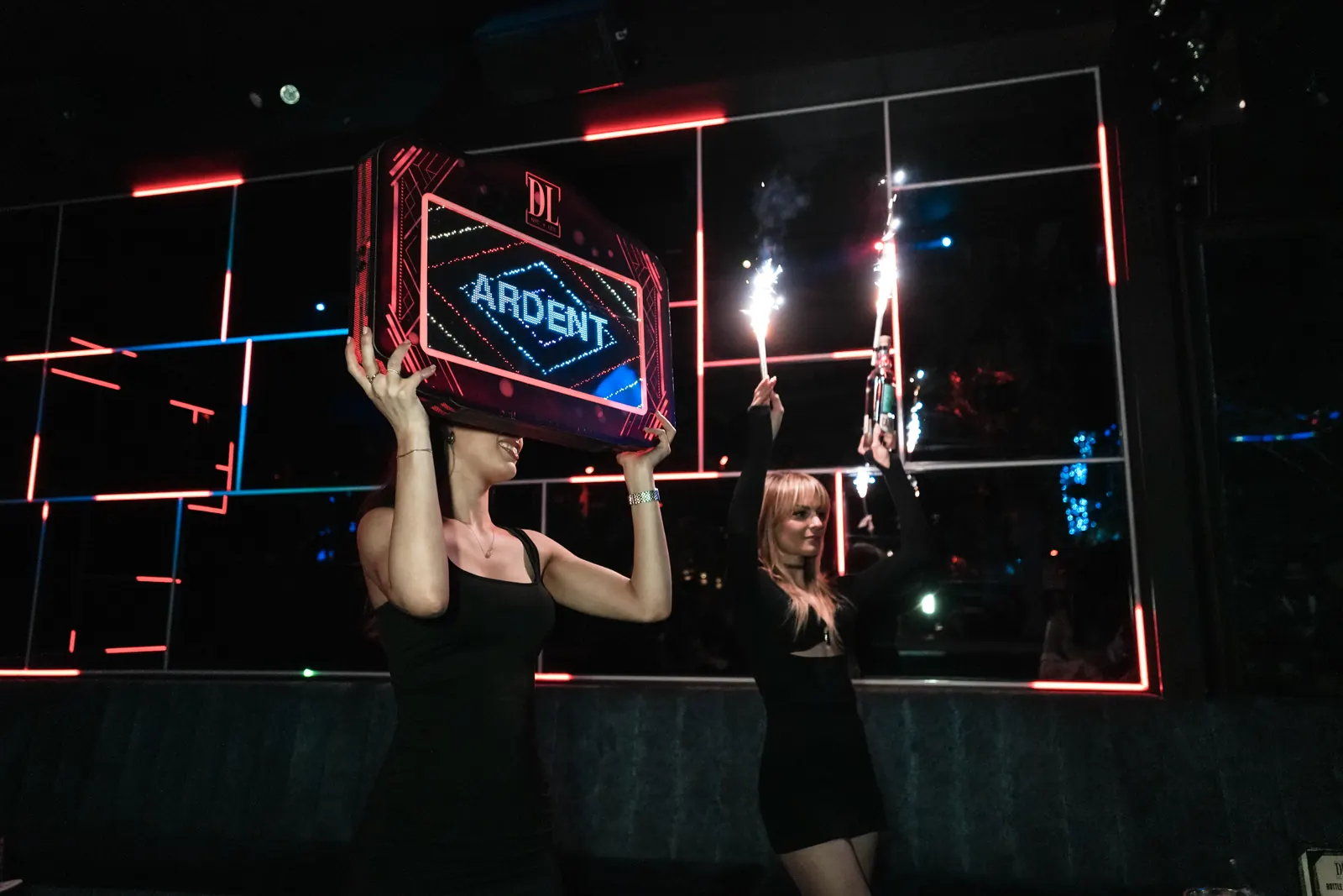 Bottle service parade with sparklers and a light-up sign at The DL