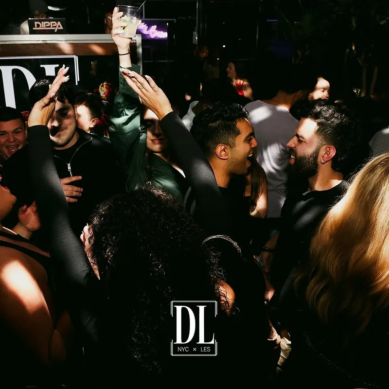 A packed dance floor with hands in the air at The DL