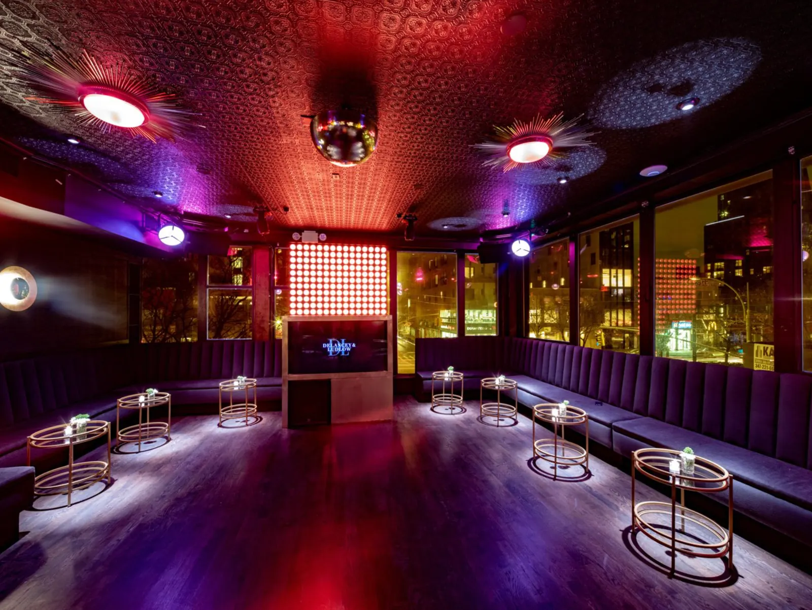 The Lounge on the second floor with its red LED wall and velvet banquettes