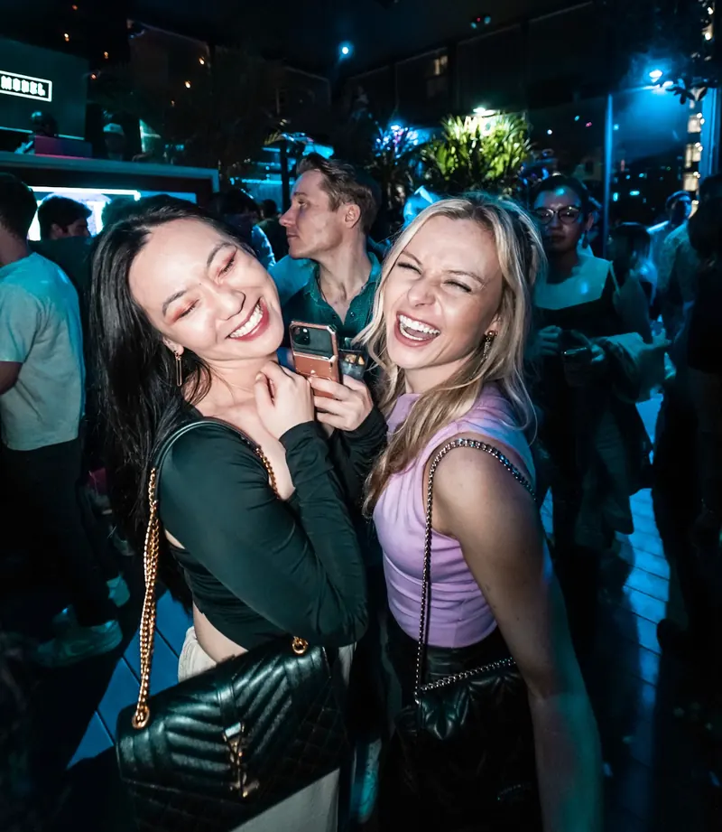 Two friends laughing together at The DL
