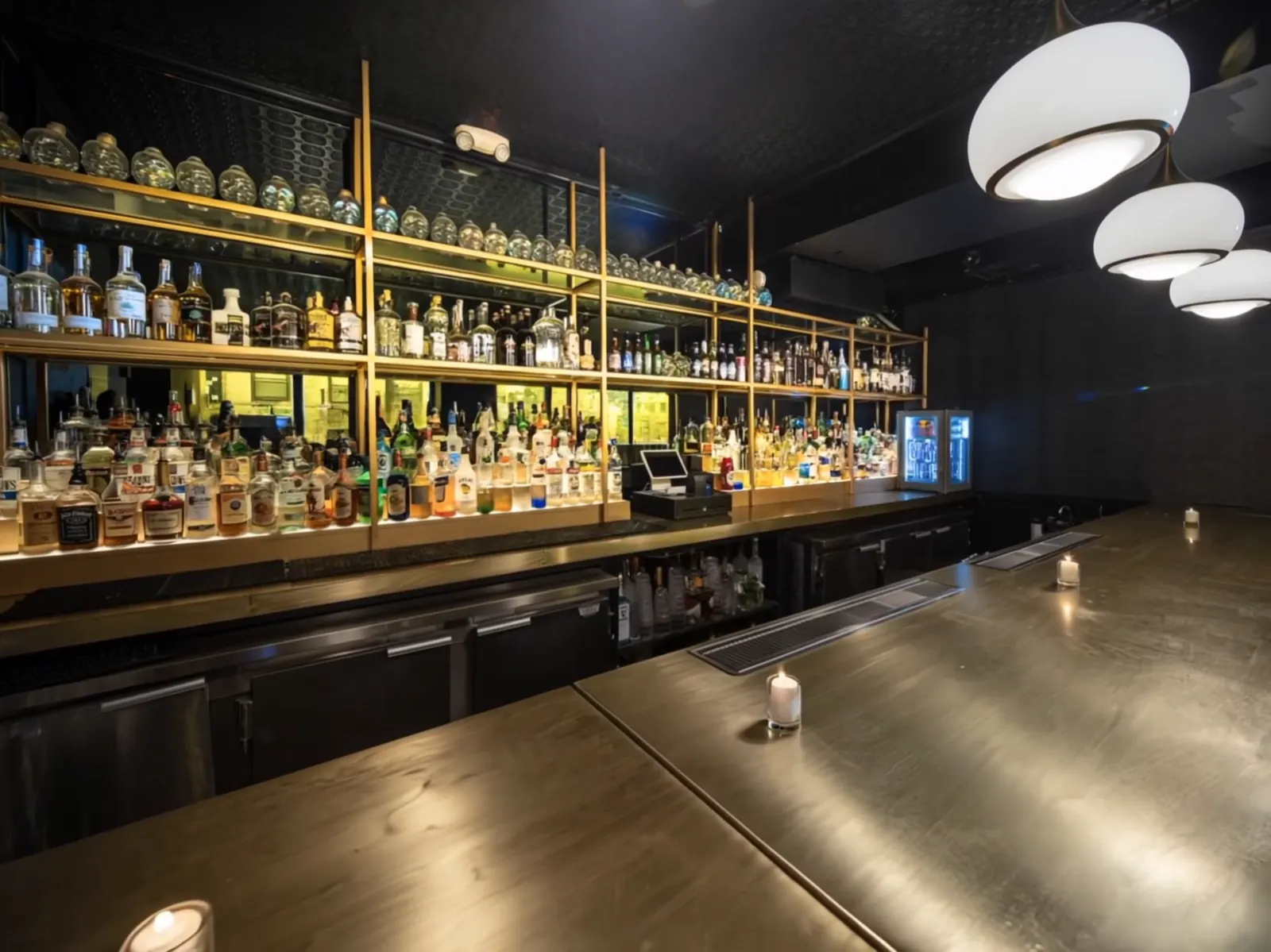 The Lounge's gold back bar and globe pendants