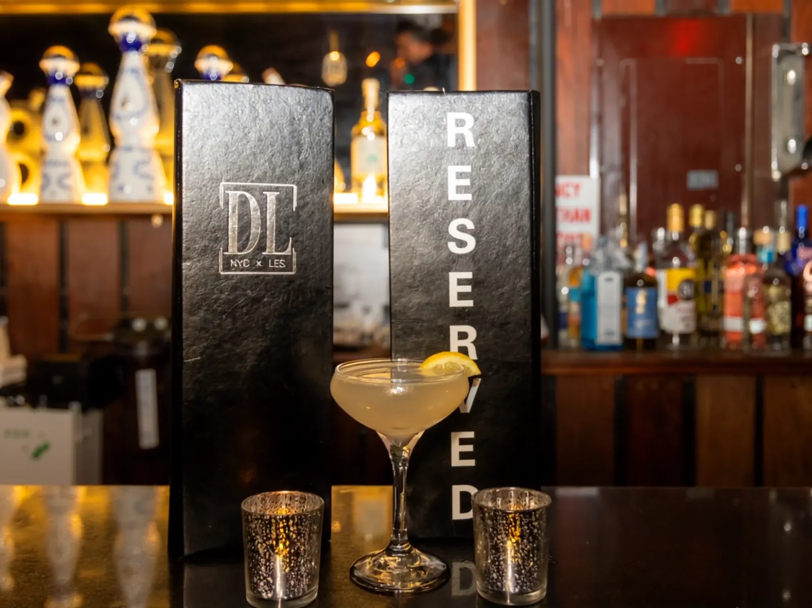 The RESERVED sign and a cocktail on the bar